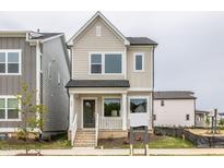 Two-story house with light beige siding, white trim, and a front porch at 515 Wendover Pkwy, Pittsboro, NC 27312