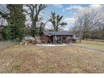 Brown house with yard, partially covered in snow at 620 S Mebane St, Burlington, NC 27215