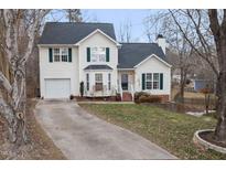 Two-story house with attached garage and landscaped yard at 1006 Silent Retreat Ln, Knightdale, NC 27545