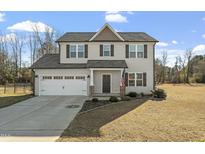 Two-story house with gray siding, brown roof, and a two-car garage at 105 Langdon Chase Way, Selma, NC 27576