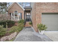 Brick home with 2-car garage, walkway, and landscaping at 105 Sundew Ln, Cary, NC 27518