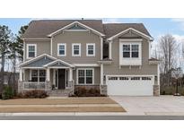 Two-story house with gray siding, white trim, and a stone facade at 105 Tayberry Ct, Holly Springs, NC 27540