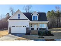 Two-story craftsman home with white siding, stone accents, and a two-car garage at 1116 Prominence Dr., Homesite 31, Durham, NC 27712