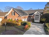Brick home with landscaped yard and driveway at 1231 Champions Pointe Dr, Durham, NC 27712
