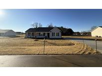 New construction home with gray siding and a black roof at 128 Pate Landing Dr, Selma, NC 27576