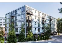 Contemporary apartment building featuring modern architecture, balconies, and lush landscaping at 1300 St Marys St # 403, Raleigh, NC 27605