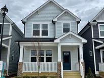 Charming two-story home with blue accents and a cozy front porch for relaxing and enjoying the outdoors at 1364 Barreto Dr, Wendell, NC 27591
