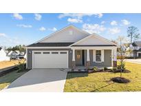 Gray Craftsman style home with white garage door and landscaping at 14 Baird Cv Ln, Angier, NC 27501