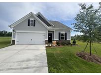 Charming one-story home with a well-manicured lawn and a two-car garage at 14 E American Marigold Dr # 65, Benson, NC 27504