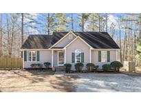 Cute ranch home with green shutters and landscaped yard at 204 Percheron Dr, Zebulon, NC 27597