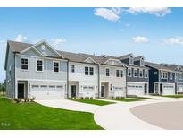 New townhomes featuring unique color schemes, attached garages and manicured lawns at 8703 Wardle Ct, Wake Forest, NC 27587