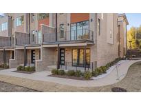 Beautiful new brick townhomes offer outdoor space, balconies, and modern exterior lighting at 1016 Manor Way, Durham, NC 27701