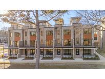 Modern three-story townhouses with balconies and neutral brick exterior at 1018 Manor Way, Durham, NC 27701