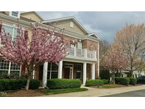Charming two-story brick home with a balcony and flowering trees in a well-manicured front yard at 10511 Sablewood Dr # 110, Raleigh, NC 27617