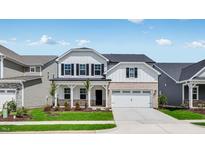 Charming two-story home featuring a well-manicured lawn and a welcoming front porch at 1705 Clydner Dr, Cary, NC 27523