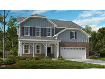 Two-story home with gray siding, brick accents, and a white porch at 1705 Clydner Dr, Cary, NC 27523