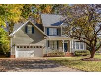 Two-story house with gray siding, white garage door, and landscaping at 202 Oakmont Ct, Mebane, NC 27302