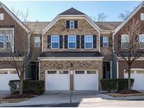 Brick front exterior of charming townhome with two-car garage at 222 Kylemore Cir, Cary, NC 27513
