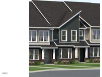 Charming townhome exteriors feature varied siding, black roofs, and manicured landscaping at 3021 White Rail Dr, Fuquay Varina, NC 27526