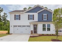 Two-story house with white and blue siding, a two-car garage, and a landscaped lawn at 37 Baird Cv Ln, Angier, NC 27501