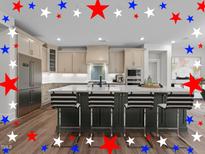 Beautiful kitchen with light cabinets, stainless steel appliances, and spacious island with seating at 645 Silvercomet Dr, Knightdale, NC 27545