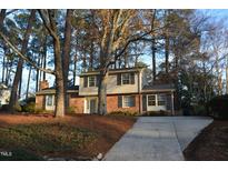 Brick house with gray accents and a large tree in the front yard at 805 Richmond St, Raleigh, NC 27609