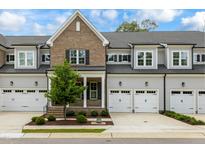 Brick front townhome with 2-car garage and landscaped yard at 1135 Laurelwood Dr, Durham, NC 27705