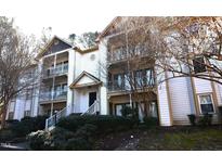 Two-story condo building with multiple balconies and landscaping at 1511 Creekwood Ct # 102, Raleigh, NC 27603