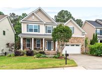 Charming two-story home featuring a manicured lawn, stone accents, and a welcoming front porch at 200 Callandale Ln, Durham, NC 27703