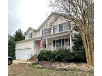 Charming two-story home with a welcoming front porch and manicured landscaping at 2421 Barton Oaks Dr, Raleigh, NC 27614