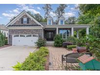 Two-story house with stone accents, a large front porch, and a landscaped yard at 2421 Beckwith Rd, Apex, NC 27523