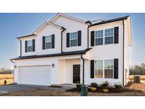Two story house with white siding, black shutters, and a two car garage at 308 Johnson Ridge Way, Four Oaks, NC 27524
