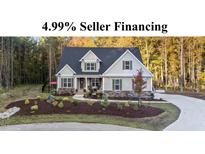 Inviting two-story home with manicured front yard, charming porch, and lush landscaping at 40 Yellowstone Ct, Youngsville, NC 27596