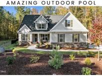 Two-story house with gray siding, stone accents, and landscaped yard at 40 Yellowstone Ct, Youngsville, NC 27596