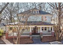 Two story home with a large front porch and mature trees at 520 Polk St, Raleigh, NC 27604