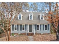 Gray two-story house with shutters, landscaping, and a walkway at 706 Sleepy Creek Dr, Durham, NC 27713
