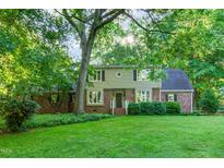 Charming two-story home with lush lawn and mature trees at 11712 Black Horse Run, Raleigh, NC 27613