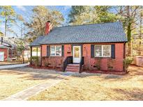 Brick house with gray roof, landscaping, and walkway at 1305 Hammond St, Rocky Mount, NC 27803