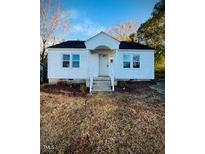 Charming white house with gray roof and front steps at 1410 Second St, Henderson, NC 27536