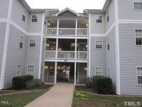 Three-story apartment building with multiple balconies and ample parking at 1911 Wolftech Ln # 102, Raleigh, NC 27603