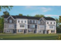 Modern 3-story townhome with light gray siding and a white trim at 2251 Horton Park Dr, Apex, NC 27539