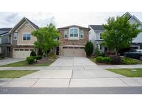 Brick front two-story home with attached two-car garage and landscaping at 248 Begen St, Morrisville, NC 27560