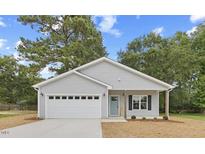 Charming one-story home with gray siding, white trim, and a two-car garage at 435 Iris Bryant Rd, Dunn, NC 28334
