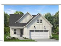 Two-story craftsman style home with gray siding, white trim, and a two-car garage at 524 Gainer Dr # 7, Raleigh, NC 27610