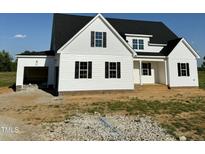 Charming new construction home featuring white siding, black shutters, and a spacious two car garage at 5377 River Buck Rd, Spring Hope, NC 27882