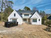 Two-story craftsman style home with white siding and dark roof at 5820 Shawood Dr, Raleigh, NC 27609