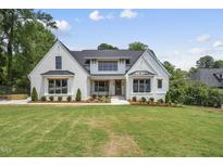 A beautiful, newly constructed two-story home with white painted brick and a well-manicured lawn at 5820 Shawood Dr, Raleigh, NC 27609