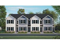 Three-unit townhome building, gray and white exterior, landscaped lawn at 8617 Brixton Shay Dr, Raleigh, NC 27616