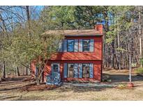 Two-story red house with gray shutters, front yard, and wooded backdrop at 9 Misty Creek Ct, Durham, NC 27705