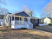 Charming ranch home with updated brick exterior, welcoming porch, and landscaped yard at 1014 E Jones St, Raleigh, NC 27601